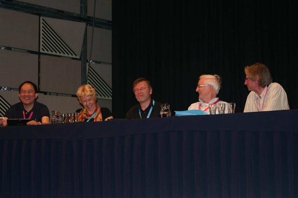 5 people sitting at a conference table with a blue tablecloth